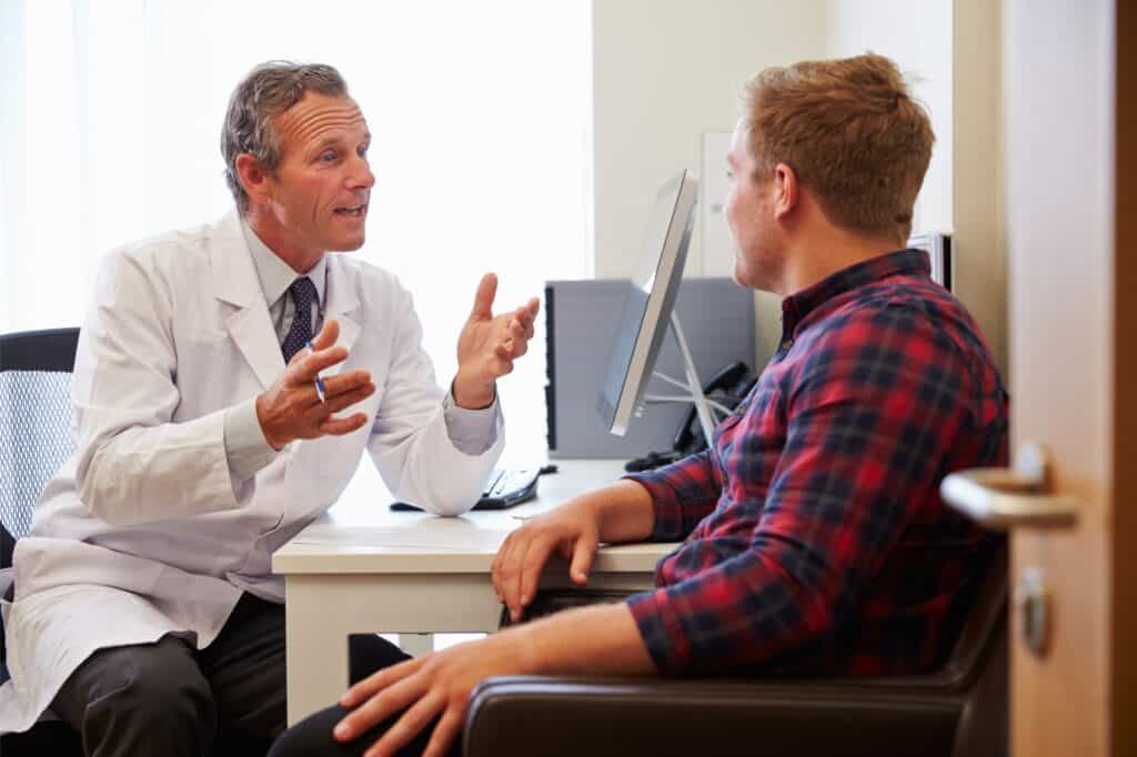 A man discusses a recovery plan with his doctor during detox in Philadelphia.