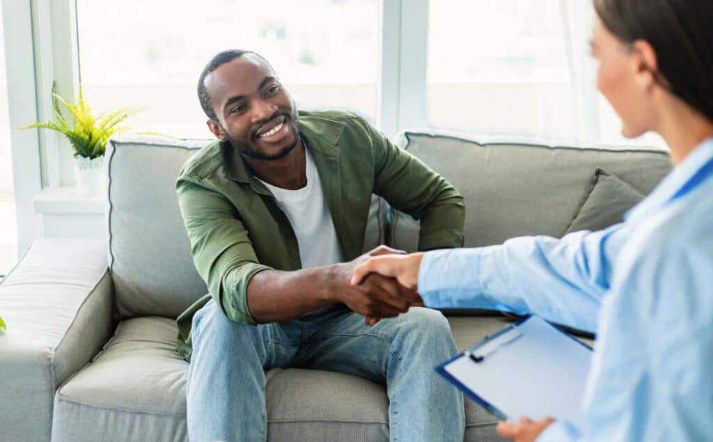 Man greeting his therapist at a session of cognitive behavioral therapy in Philadelphia.