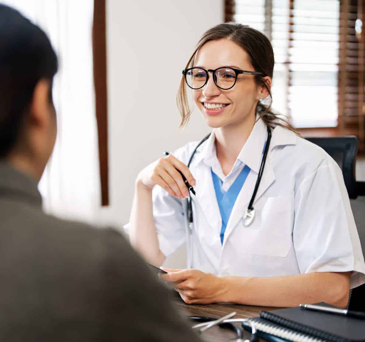 Physician conducting a client assessment for substance use treatment.