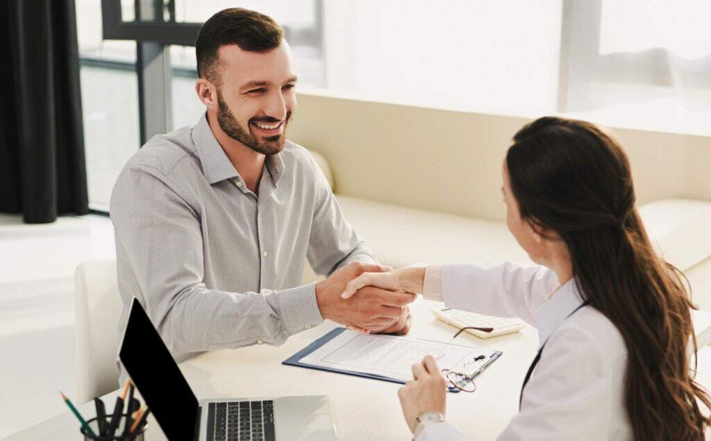 Man shaking hands with professional during Philadelphia case management.
