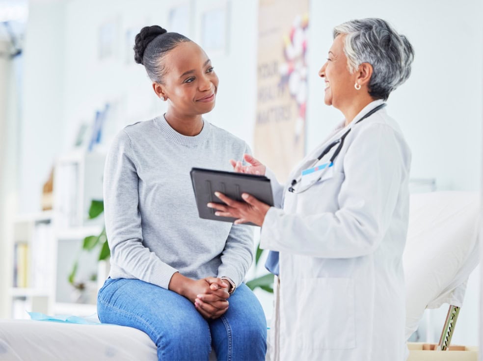 A woman discussions personalized options for medication management in Philadelphia with her doctor.
