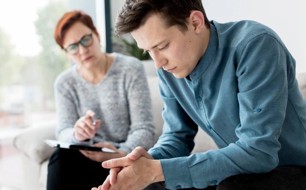 Man receiving emotional support during rehab for young adults in Philadelphia.