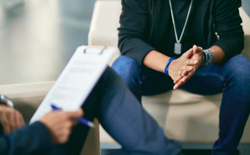 Man consulting a professional about PHP vs IOP treatment.