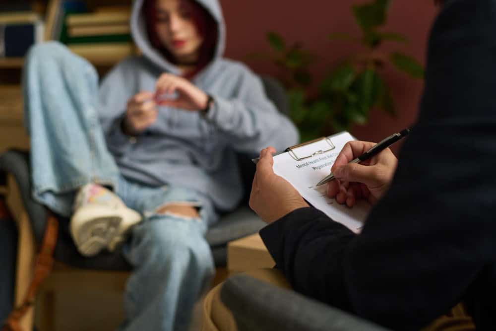 Psychologist taking notes during hydrocodone addiction treatment in Philadelphia counseling session
